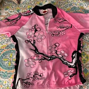 Cute biking jersey. Pink, black white with storage pouch on back.